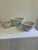 A classic set of three vintage white stoneware mixing bowls in graduated sizes. The bowls feature substantial rolled rims,...