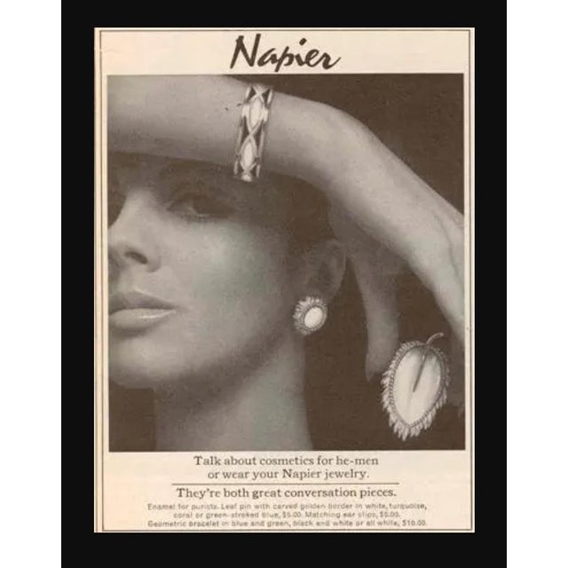 Circa 1966 goldtone and molded red resin leaf brooch with security clasp. Marked "NAPIER©" on the back of the stem....