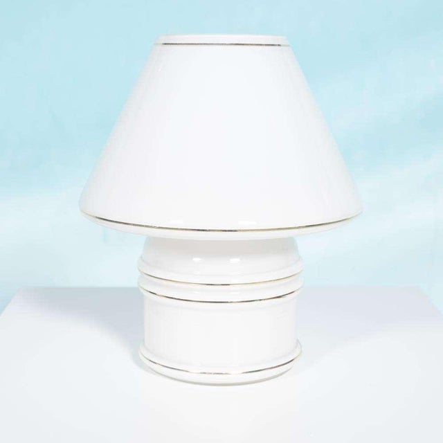 Cool table lamp made from milk glass from the seventies. This large frosted glass table lamp immediately brings atmosphere...