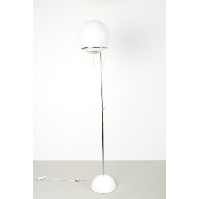 Vintage italian floor lamp in space-age style with an opaque glass shade which gives a beautiful diffuse light. The height...