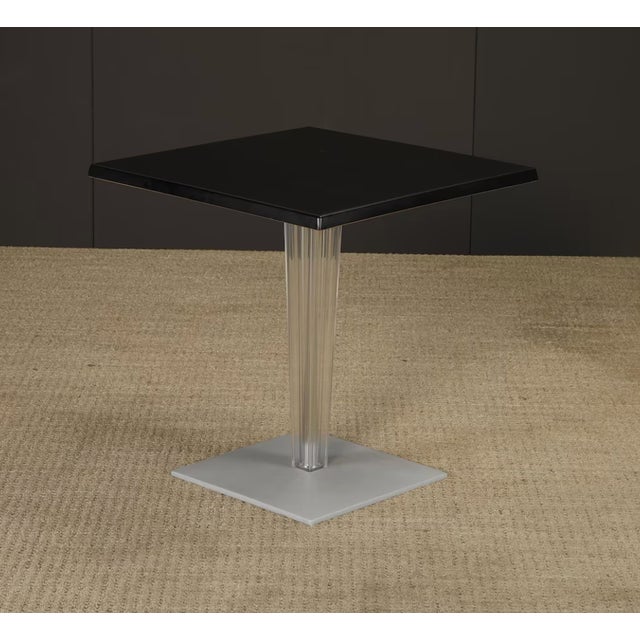 Sculptural vintage side table by Kartell, featuring a striking combination of a clear fluted acrylic pedestal base and a...