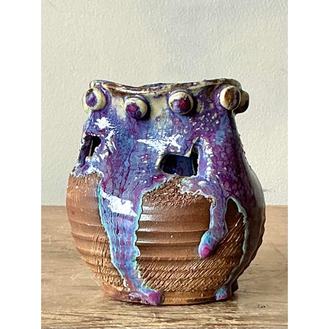 Discover the tactile allure and expressive form of this petite vintage studio pottery vessel. A unique example of...