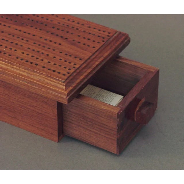 This wonderful cribbage board and box has just two metal pegs. It's in excellent condition; I presume it's at least 50...