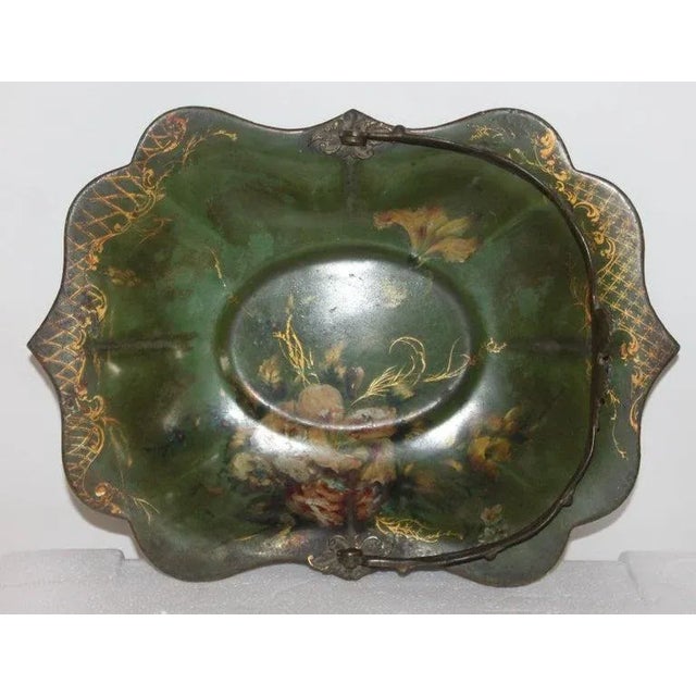 This fine hand painted metal basket with the enamel green base. The condition is very good.
