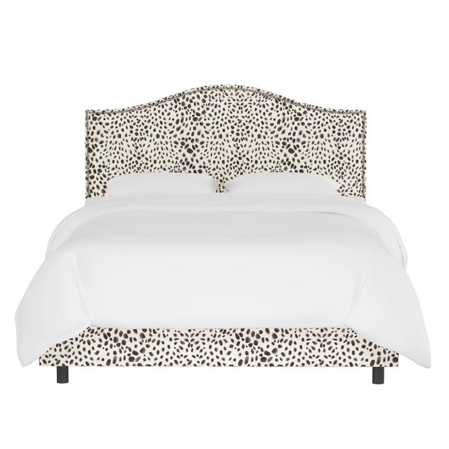 Give your interior a lift with the Bed. Featuring the delicate curves of a classic camelback design, with subtle nailhead...