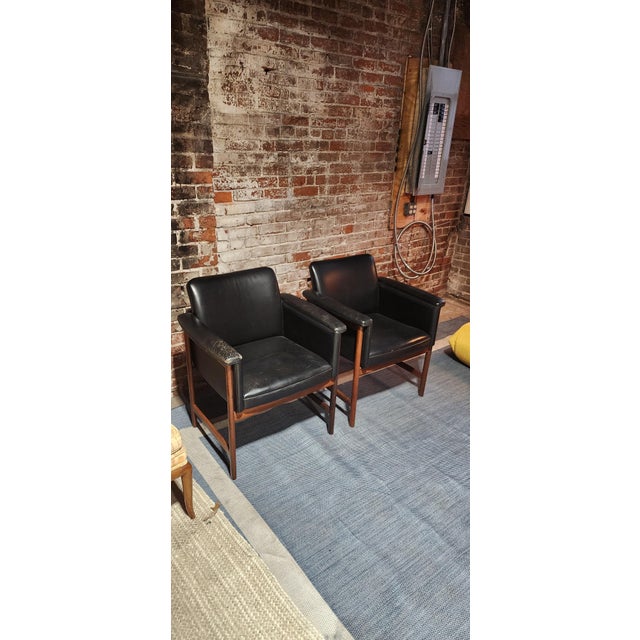 A pair of Scandinavian modern lounge chairs designed by Torbjørn Afdal for Haug Møbelsnedkeri, crafted in richly figured...