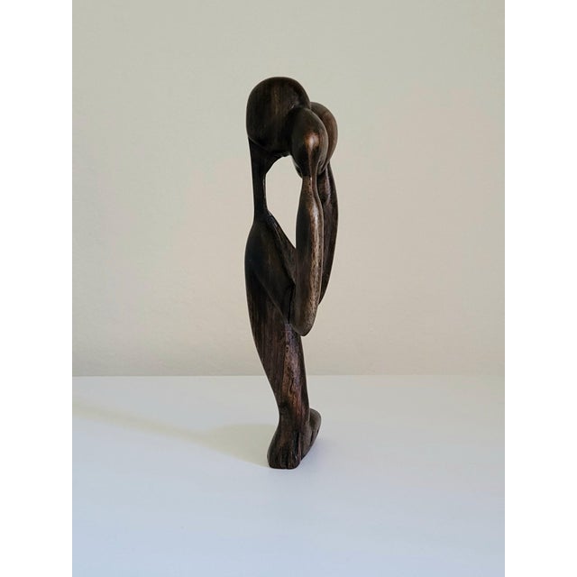 African modernist "thinking man" statue with beautiful patina, abstract proportions, and smooth touch. Deeply colored...
