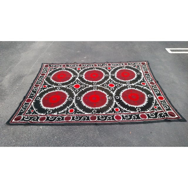 This a great and very detailed Vintage Bukhara Suzani Tapestry from Uzbekistan, that is hand-woven on a off-white...