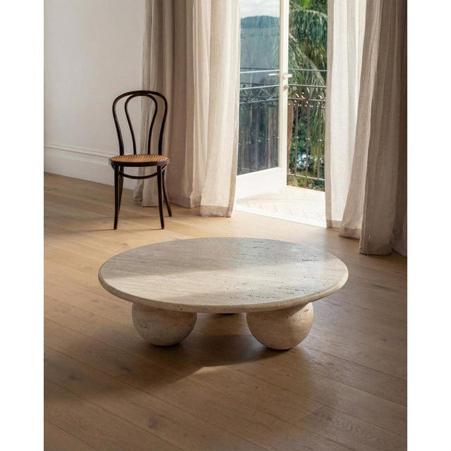Crafted from a single material, this sculptural coffee table features a 3 cm thick, bullnose-edged top supported by three...