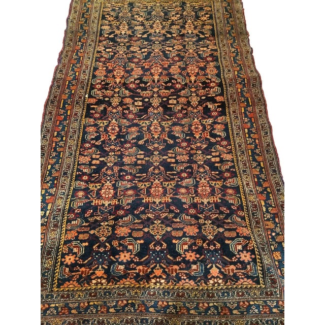 Early 20th Century Vintage Persian Senneh Area Rug, meticulously hand-knotted circa the early 1900s. This captivating area...
