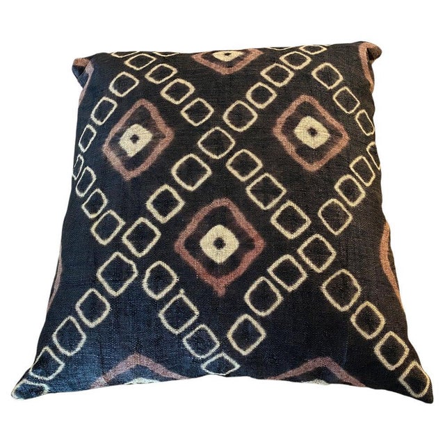 Striking double backed African resist dye raffia textile made into a pillow. Geometric design in shades of brown, orange...