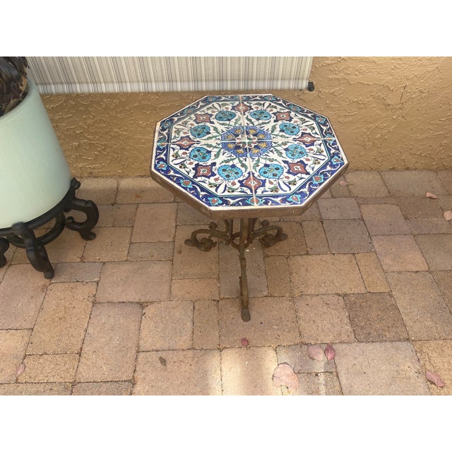 California Yellin School plant stand features wrought iron base with tripod twist foliate and scroll form legs supporting...