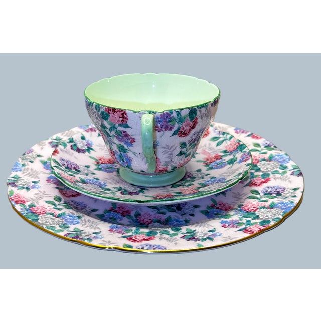 Offering a teacup, saucer, and plate from the Shelley “Stocks” (Green Interior) — Pattern 13426. This charming Shelley...
