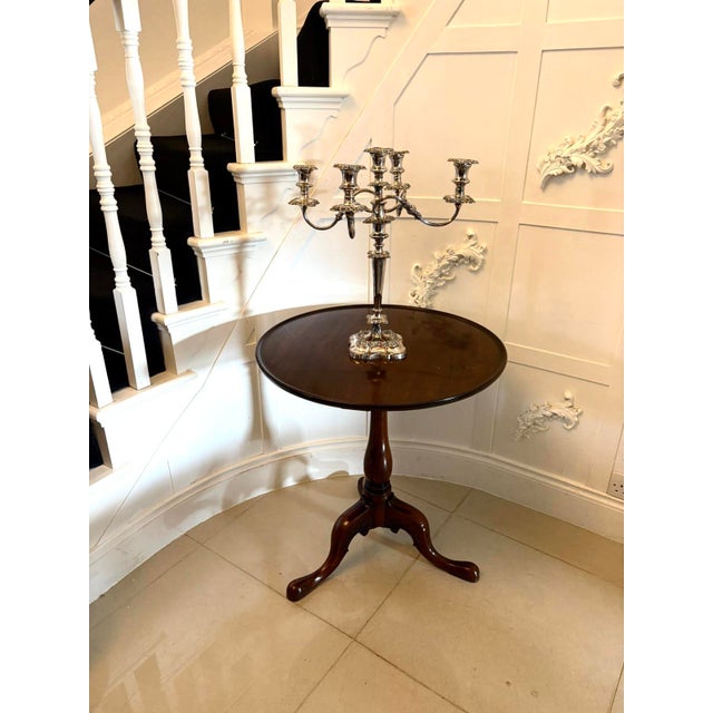 A charming antique English mahogany tripod lamp table dating from the Georgian period. The circular top displays...