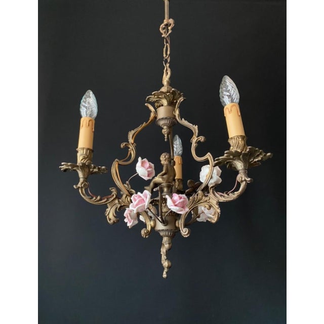 The chandelier is made of bronze and features exquisite artistic forging. It is adorned with handmade porcelain roses and...