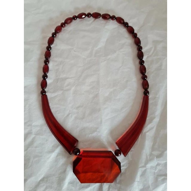 A rare and highly distinctive Art Deco cherry amber Bakelite bead necklace, dating to circa 1920s. The necklace features...