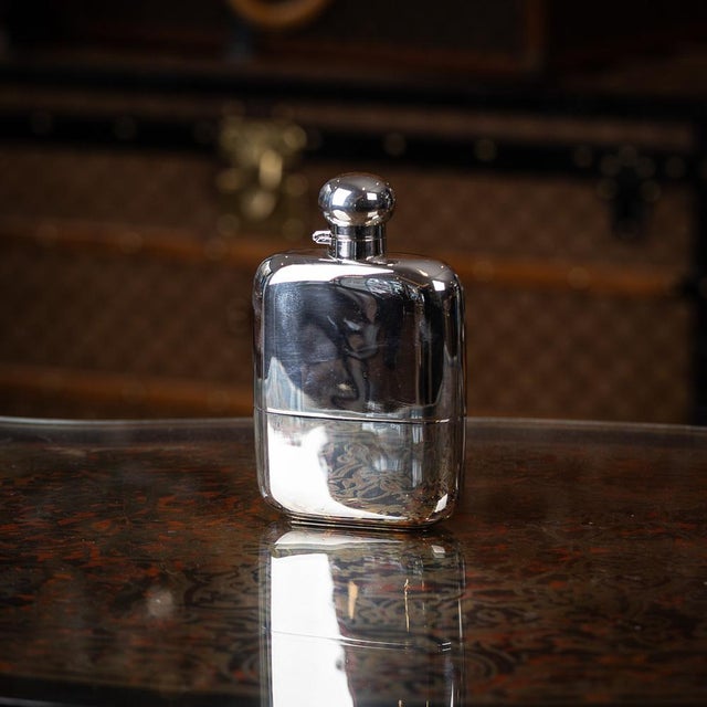 Antique early 20th century english solid silver hip flask with silver hinged top. Beautifully crafted in a polished...