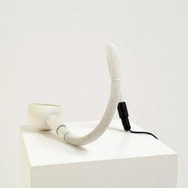 Bring a touch of playful vintage into your space with this white Hebi table lamp, designed by Isao Hosoe for Valenti in...