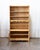 A tall Danish oak bookcase by Henning Kjærnulf, produced in the 1970s and bearing the Møbler label that confirms its...