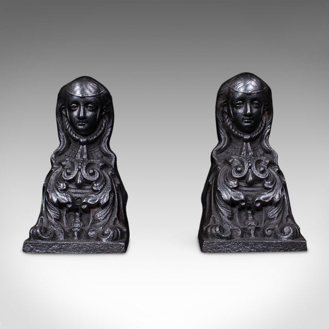 This is a pair of antique figural fireplace chenets. A French, cast iron fire wood hearth rest, dating to the Great...