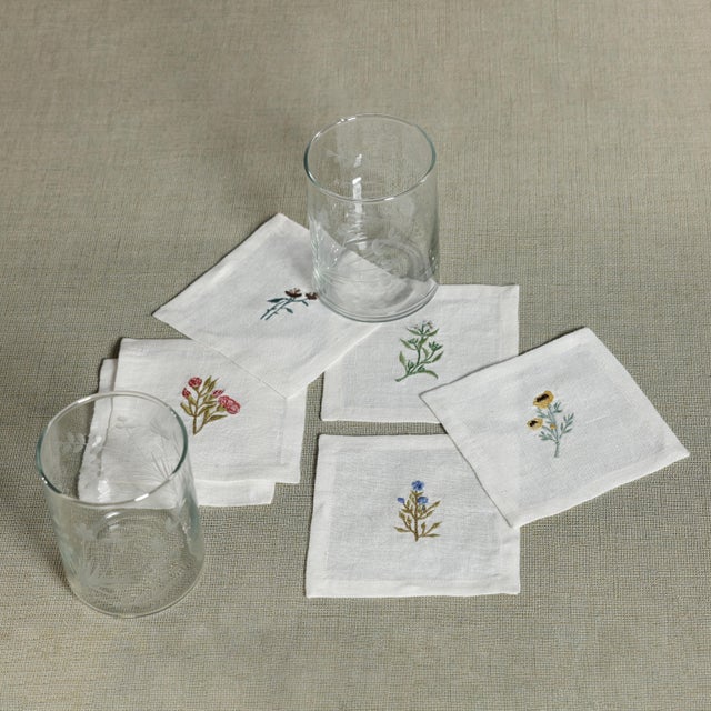 Floral Linen Cocktail Napkins - 6 Assorted Designs A set of six crisp white linen cocktail napkins, each embroidered with...