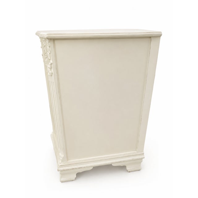 This vintage dresser has been refinished with a crisp white painted frame while preserving its spectacular bookmatched...