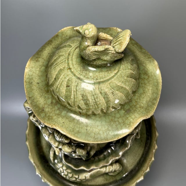 Magnificent Chinese celadon lidded vase, featuring striking three‑dimensional dragon relief winding around the neck. The...