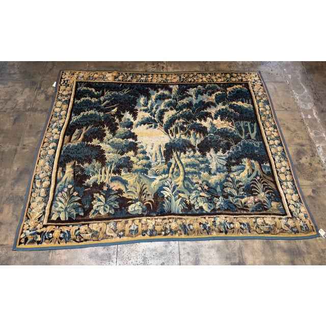 This exceptional 17th century Flemish tapestry features a richly detailed verdure landscape depicting a lush woodland...