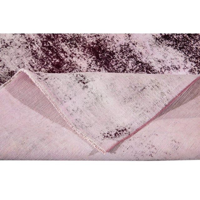 Beautiful Vintage Overydyed hand-knotted Purple Wool Rug. This rug has an all-over abstract distress design. This rug...