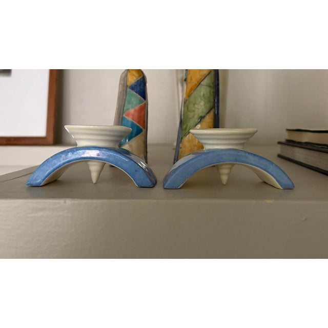 Striking pair of vintage Czech ceramic candlesticks featuring an architectural arched silhouette in soft blue and cream...