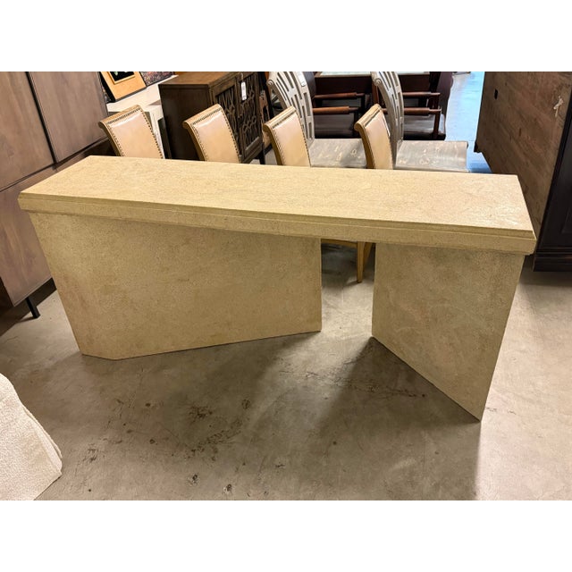 Design Plus Gallery presents a Contemporary Geometric Faux Stone Console Table. This architectural design showcases an...