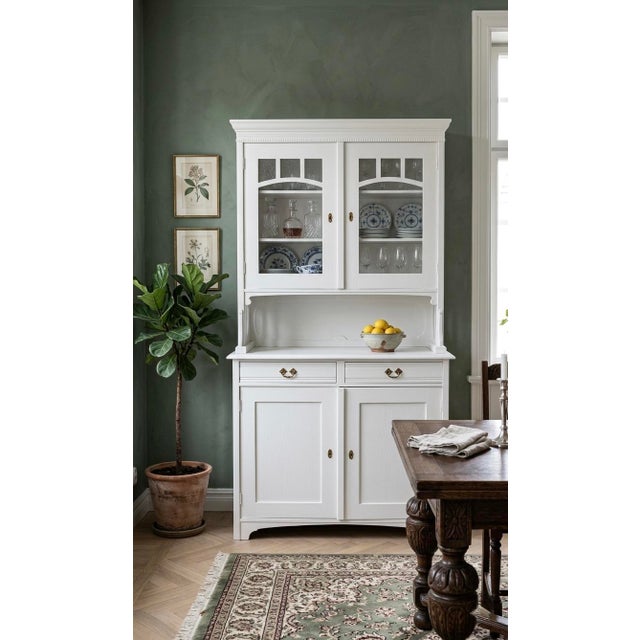 A charming restored vintage Hungarian buffet and hutch, newly painted in a crisp clean white while preserving its...
