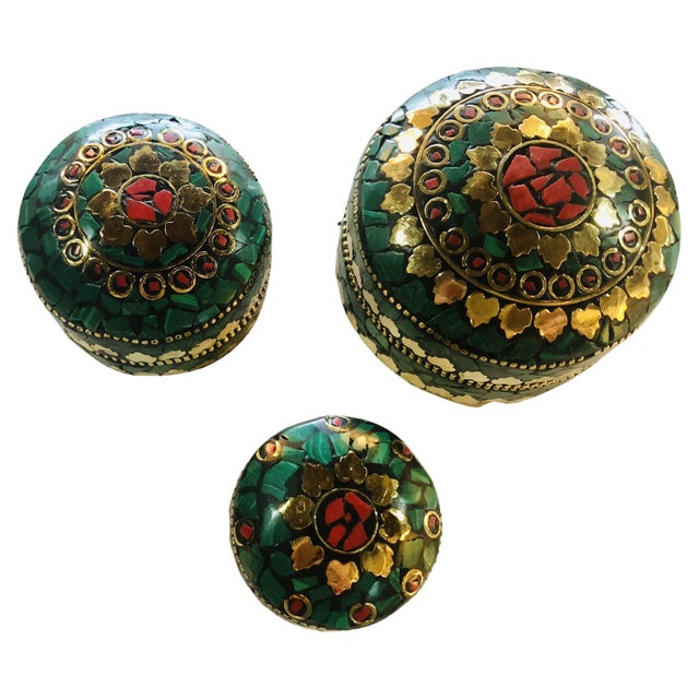 This elegant set of three round handcrafted boxes features natural Green and red stones with a fine copper finish and a...