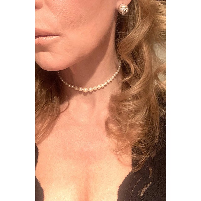 A white cultured pearl bead choker necklace with 14-kt white gold clasp, circa mid-20th century. A beautiful necklace...