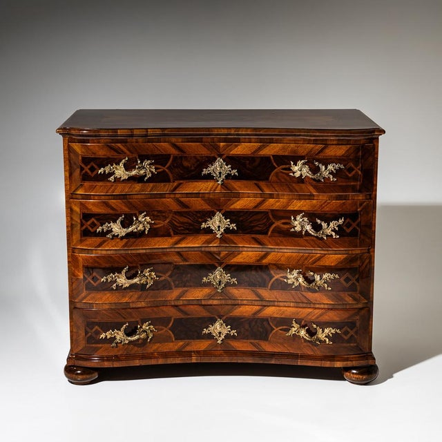 Baroque chest of drawers featuring a gently curved serpentine front and compressed bun feet. It offers four drawers...