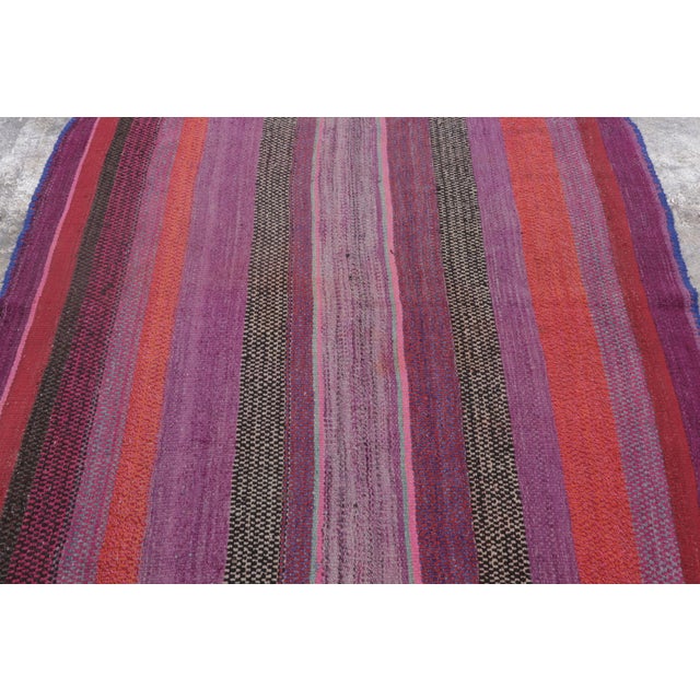 Handwoven in wool circa 1950–1960, this 5x5 vintage Kilim, woven in the tradition of a Frazada textile, is a vivid example...