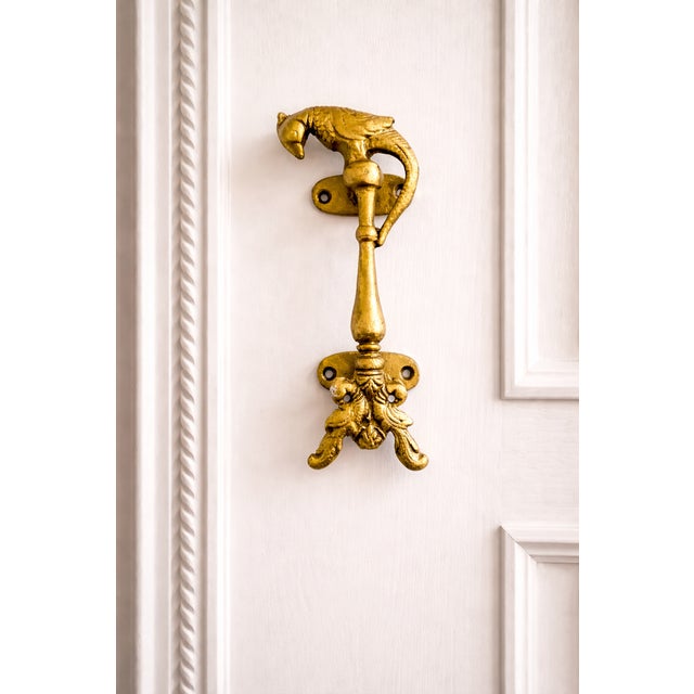 Dimensions: 2.25ʺW × 2ʺD × 6.25ʺH A striking golden decorative door handle featuring a sculptural bird motif with elegant,...