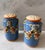 Set of hand painted cornflower blue salt and pepper shakers with swags of raised red, orange, and blue flowers. Original...