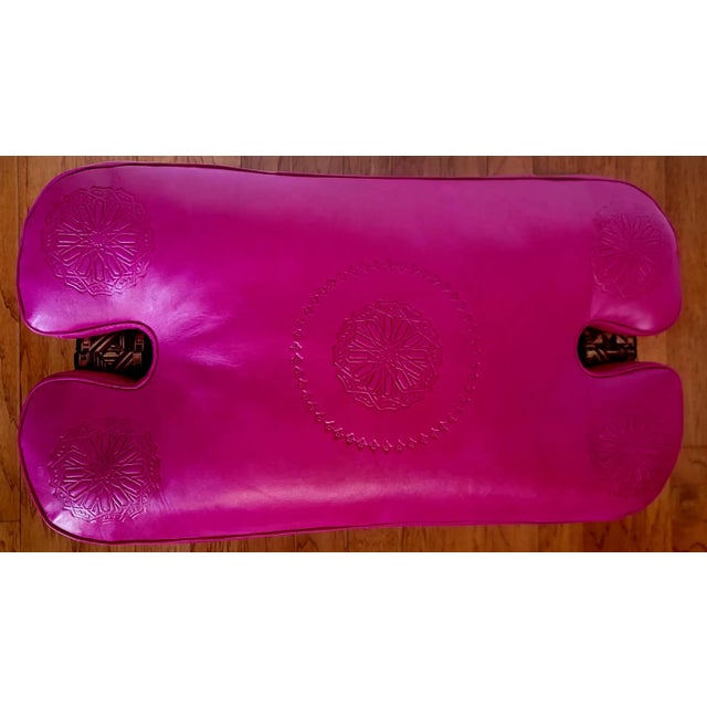 Handmade Moroccan camel saddle with genuine leather cushion and carved cedar wood base, measuring approximately 24 inches...