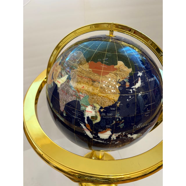 This 40" Blue Lapis gemstone floor globe featurs hand-carved, semi-precious stone continent inlays and a polished, gold...