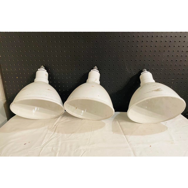 Set of 3 Industrial Enamel Light Domes. The wiring has been cut at the top and the fixtures will need to be rewired. The...