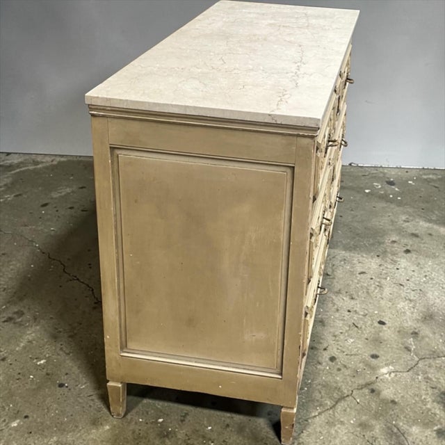 This is a 1930s French neoclassical style commode with gilt bronze hardware and a travertine top. I love this commode with...