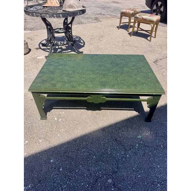 Vintage rectangular coffee table with a rich mottled green painted finish and understated chinoiserie-inspired lines. The...