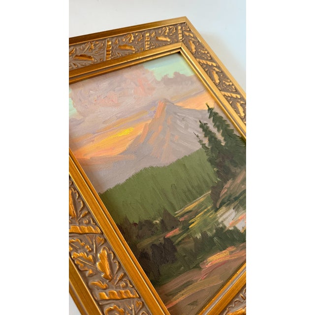 Vibrant acrylic landscape painting on canvas, depicting a flowing river at the base of majestic mountains and pines. A...