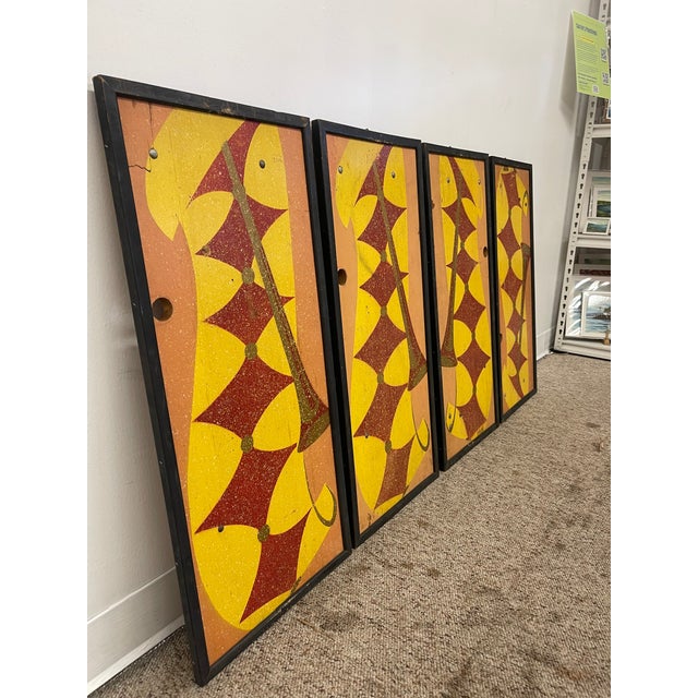 Set of four vintage geometric wall panels featuring a abstract design in yellow, orange, red, and gold tones. Each panel...