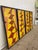 Set of four vintage geometric wall panels featuring a abstract design in yellow, orange, red, and gold tones. Each panel...