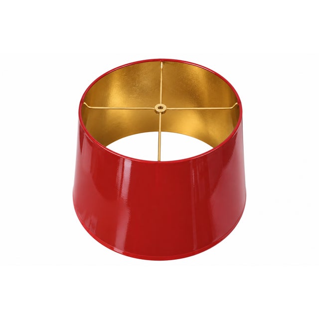This custom hand-lacquered lampshade features a high-gloss hardback exterior and a gold ponyhair-lined interior that casts...