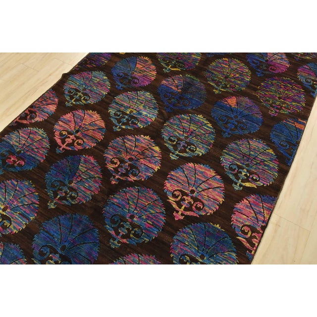 A modern Gabbeh rug hand-knotted with fine wool on a cotton foundation. This rug features rows of multicolored botanical...