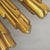 A sculptural circa-1969 Syroco starburst or sunburst wall clock with a dimensional molded-resin body, warm gold-gilt...