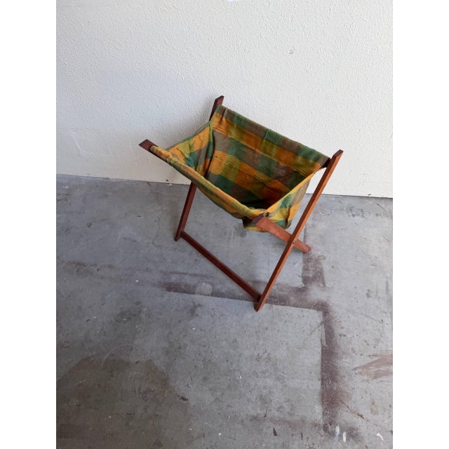 Danish Mid-Century Modern magazine rack crafted from solid teak wood. This sculptural folding design is both functional...